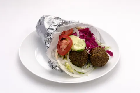 Falafel kebab with vegetables, pickled red cabbage, and tzatziki